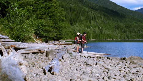 hiker couple standing near riverside 4k