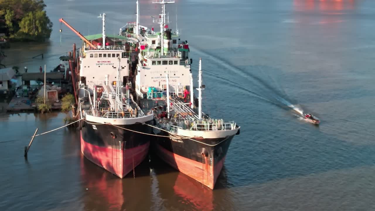 Ships docked in Bangkok with view of river and city skyline