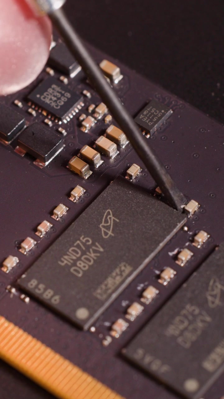 Close-up of a Tool Inspecting Microchips on a Circuit Board
