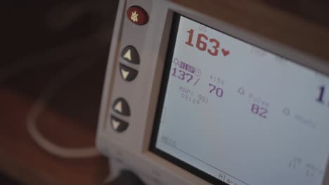 close up of a heart monitor screen taking readings on a baby inside of a pregnant ladies belly