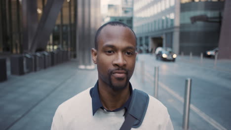 african american businessman walking through city