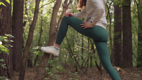 woman stretching in the forest