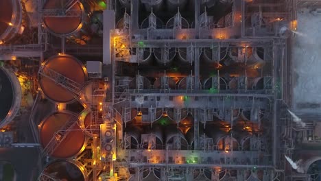 Drone-top-down-of-metal-factory-at-dusk