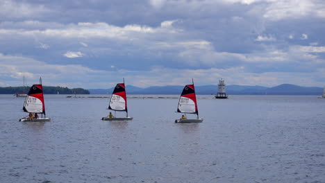 Small-sailboats-in-the-harbor-with-lighthouse