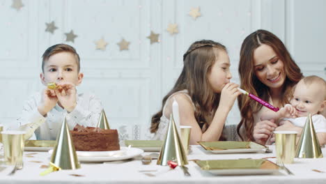 three cute kids walking around christmas tree in living room