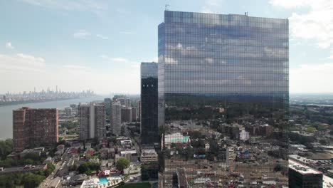 massive luxury high-rise complex with manhattan skyline in the distance