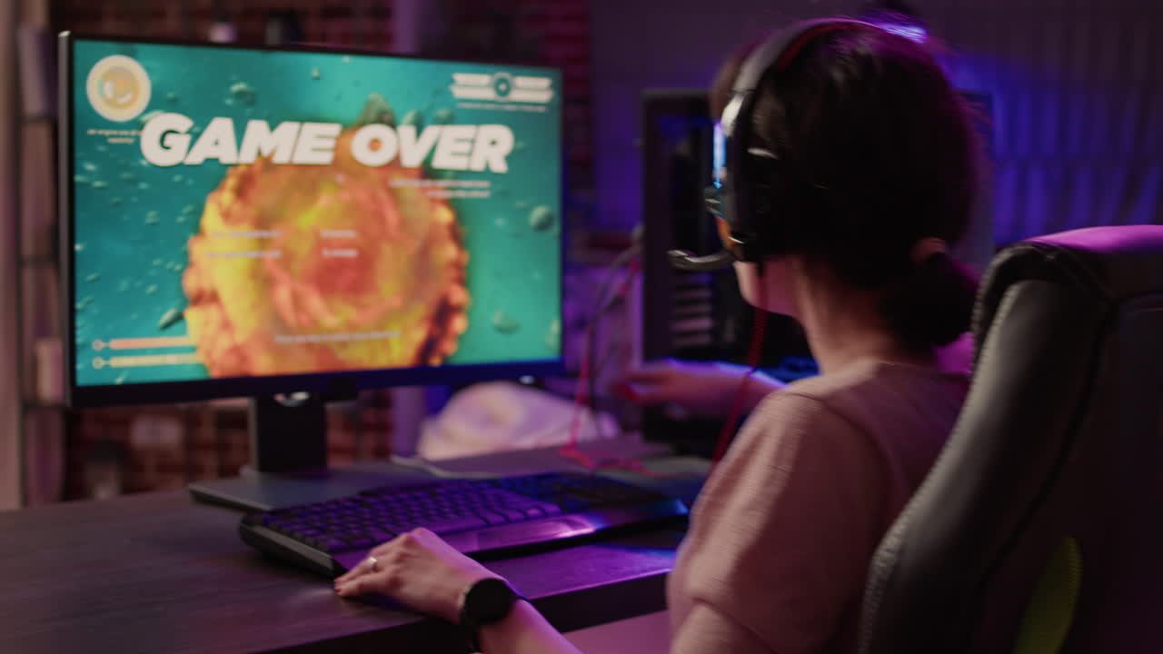 Gamer girl feeling shouting at computer screen after losing difficult level in online space shooter