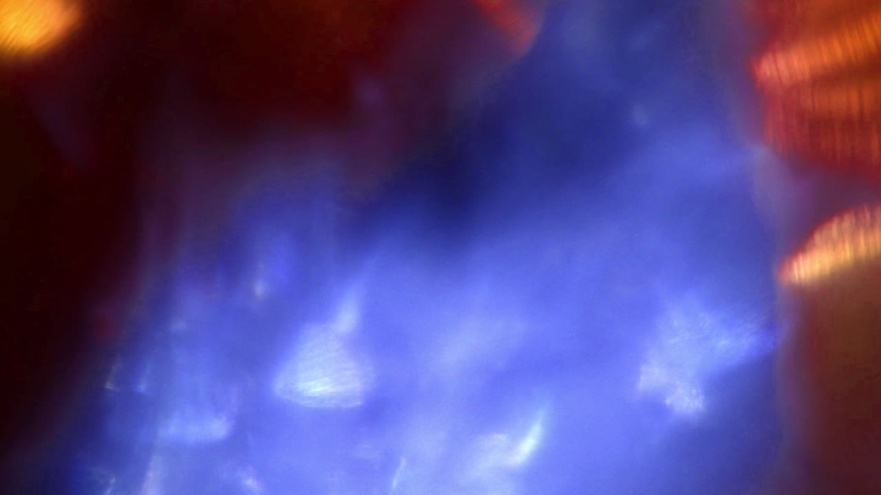 Abstract Blue and Orange Light Leaks Moving on Dark Background