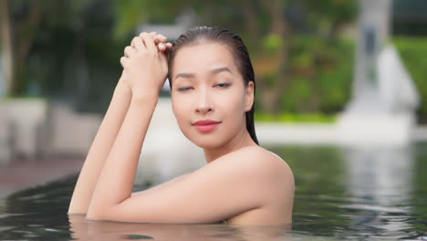 asian woman beauty posing in a pool closeup