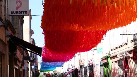 vibrant decorations adorn a street in libourne, france