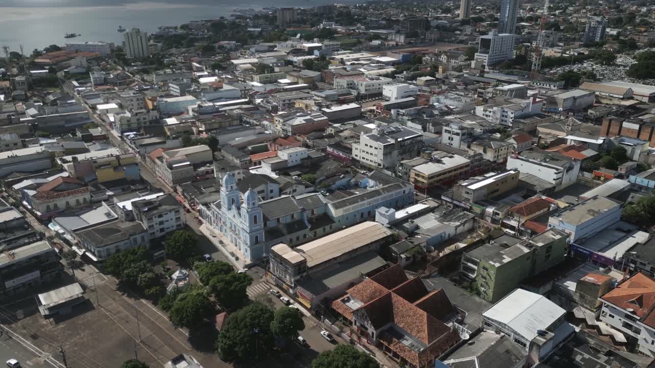 Aerial over the city of Santar&eacute;m, State of Par&aacute;, Brazil, drone fly above blue church colonial style in amazon river rainforest