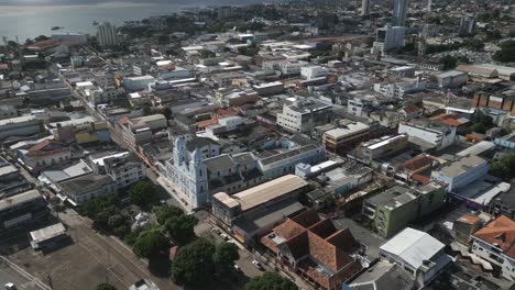 aerial over the city of santarém, state of pará, brazil, drone fly above blue church colonial style in amazon river rainforest