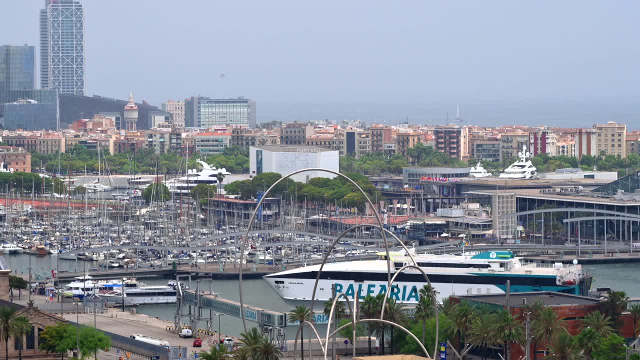 Barcelona, Spain - June 25, 2021: Aerial drone view of boats docked in the Port Vell