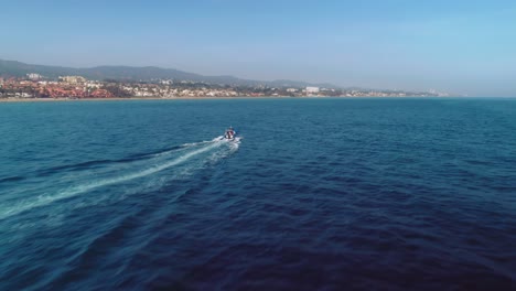 aerial drone flying over a motorboat near the spanish coastline