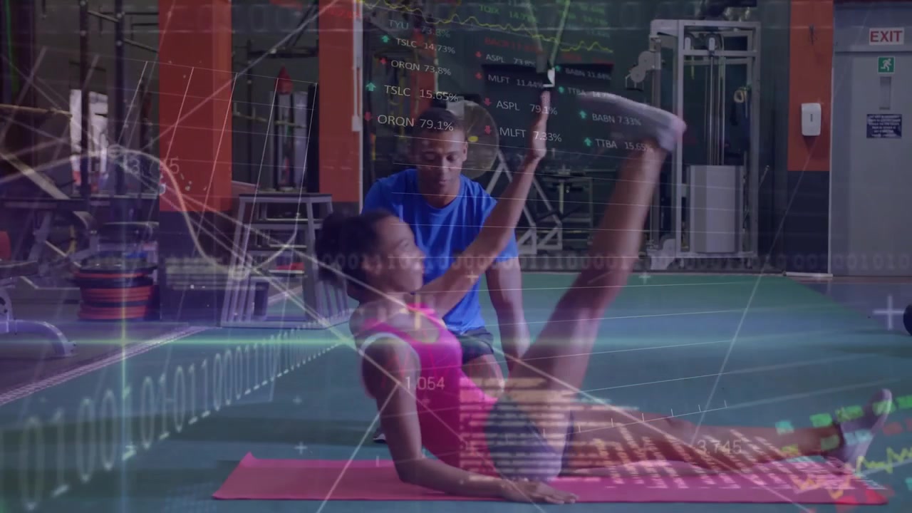 A young woman of exercising with a young man of who is her personal trainer th