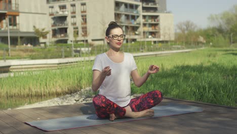 Young-woman-doing-yoga-near-home