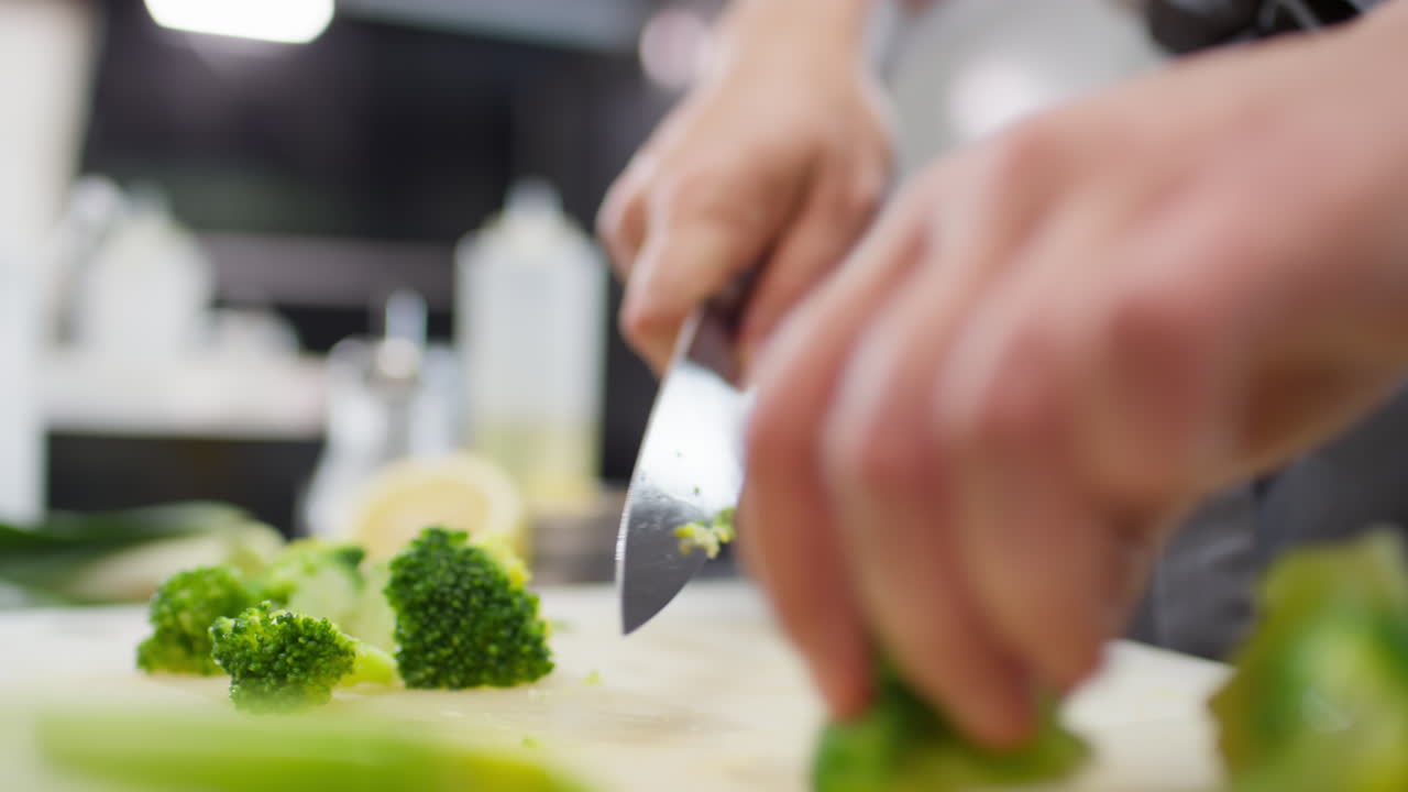 Chef Hands Cutting Broccoli