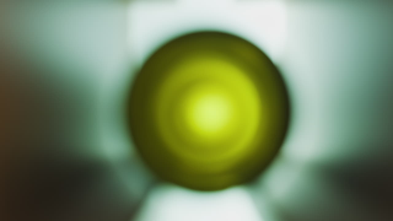 Close up of the bottom of an empty, green, wine bottle on a shelf