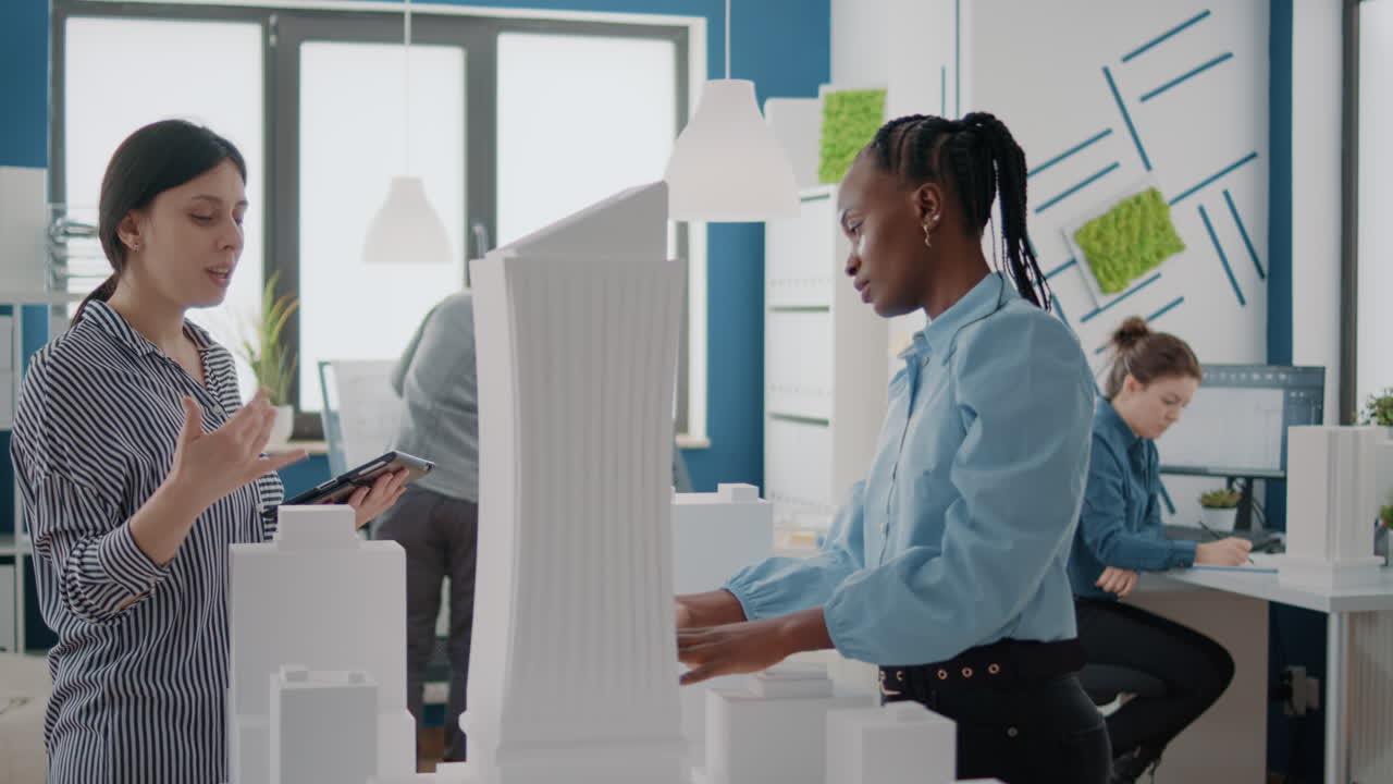 Architects collaborating on a building model in an office