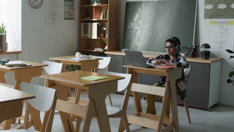 Student working on a laptop in a classroom