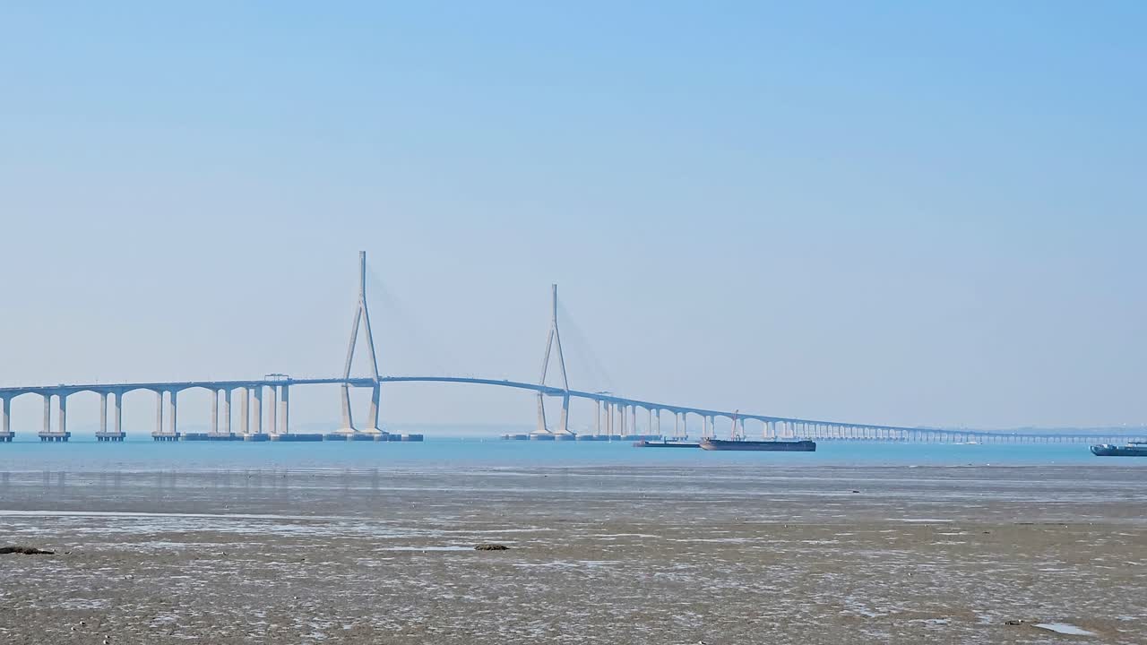 The Incheon Bridge gracefully spans the sea, linking the mainland to Yeongjong Island with its striking cable-stayed design under a clear blue sky