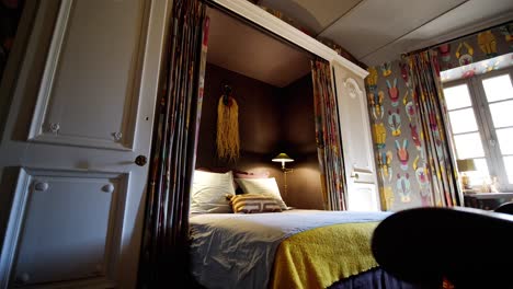 smooth wide angle shot of colourful hotel room with a big bed in natural light