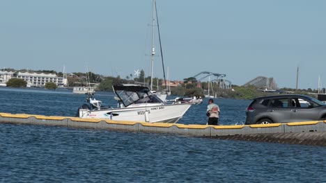 car towing boat on water near buoy