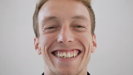 smiling caucasian male face in spectacles looking at camera