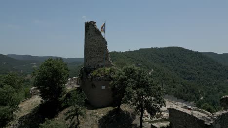 Castell-De-Calders-Ruins-And-Catalonian-Independence-Flag,-Mountains