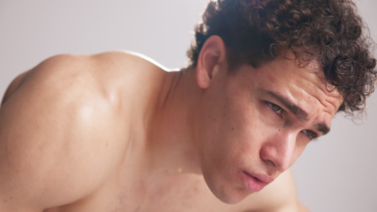 Close-up of Exhausted Young Man Sweating After Intense Workout