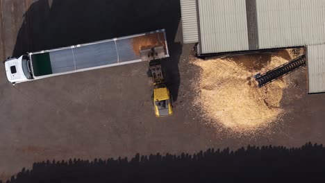 top view of lorry truck being loaded with sawdust at wood factory