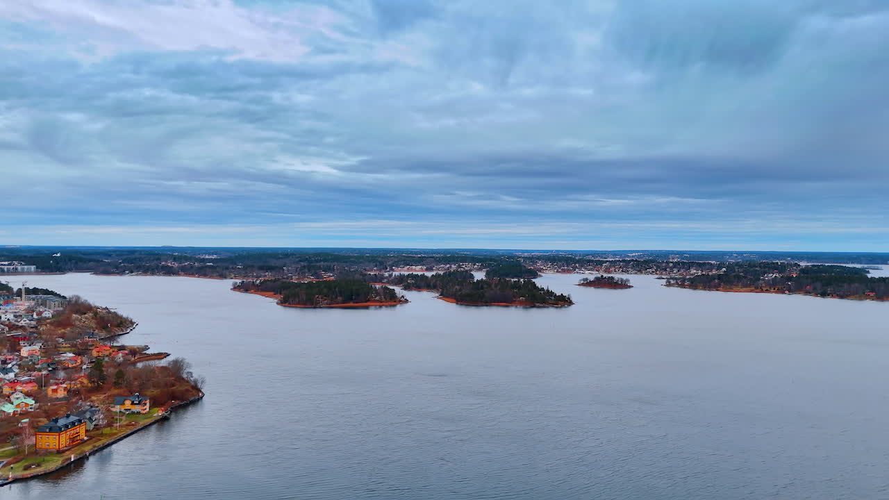 Vista panoramica sull'acqua e sulle isole in una zona costiera durante il giorno. Un'ampia veduta mostra diverse isole e acque calme sotto un cielo nuvoloso con terra in lontananza