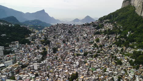 drone flying away from the rochina ghetto, in sunny rio de janeiro, brazil