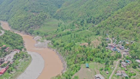 a cable car glides over green hills and a quiet village, capturing a peaceful rural landscape from above. ideal for themes of travel, nature, infrastructure, and mountain community life