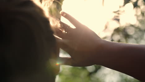 woman looking far way hiding from the sun