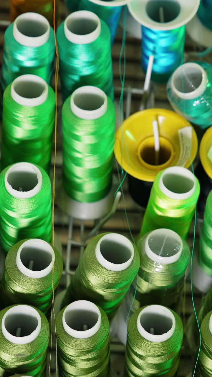 Collection of colorful threads. Different colors of threads in spools. Background of sewing threads. Handicraft concept. Vertical video