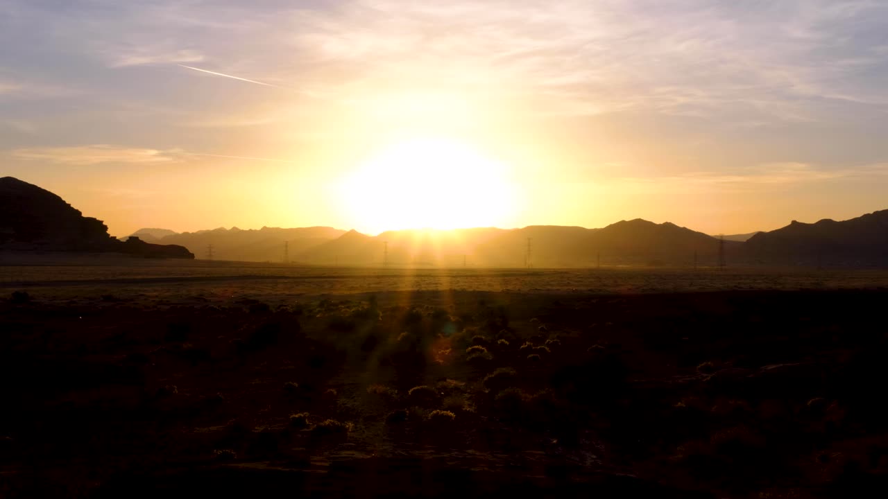 Golden sunset with final rays of sunlight over Wadi Rum desert in Jordan, Middle East, remote, mountainous landscape in the wilderness with tussocks