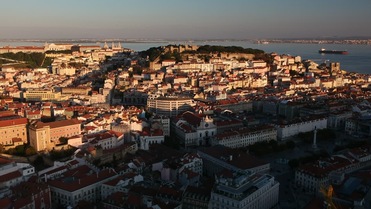 Ripresa con drone del centro storico di Lisbona e del Castello di São Jorge al tramonto, Portogallo