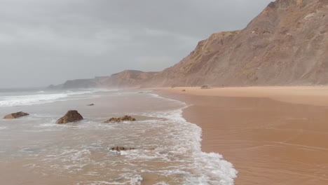 Aerial-drone-view-of-the-deserted-empty-rocky-beach-and-cliffs-in-Portugal