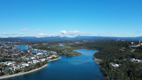 scenic panorama of tallebudgera creek with the gold coast hinterland and cloud formation in the foreground