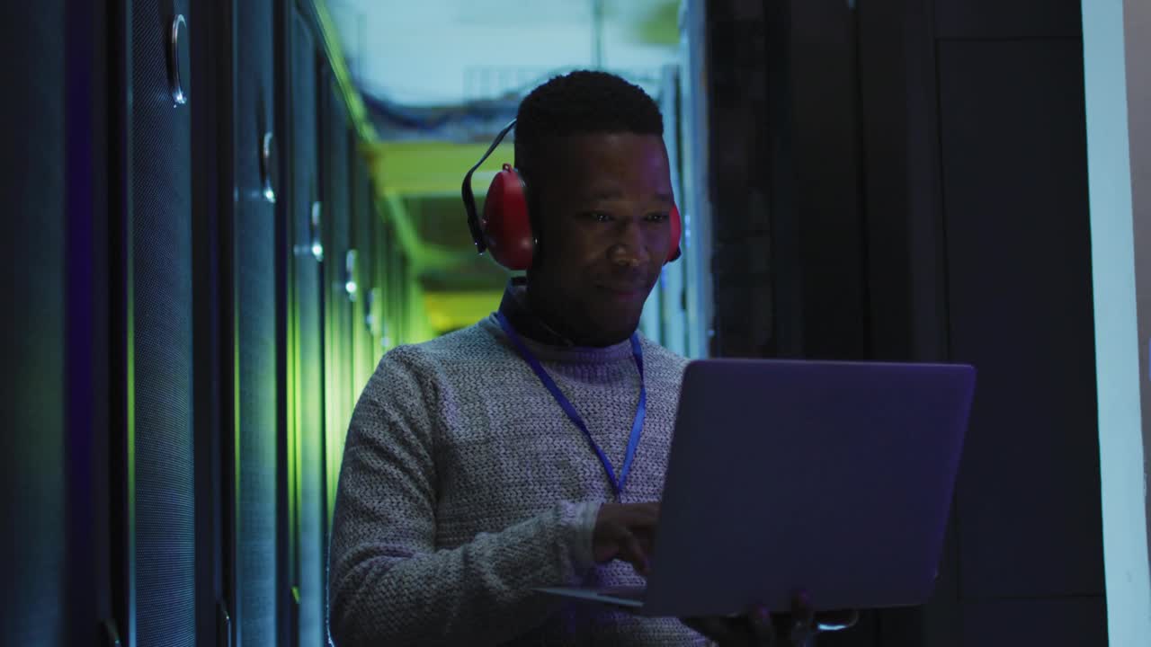 IT-tekniker tjekker racks, taster på bærbar computer, mens ABONNER UI-skydemærker vises og hober sig op på den bærbare computer.