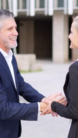 business professionals shaking hands outdoors