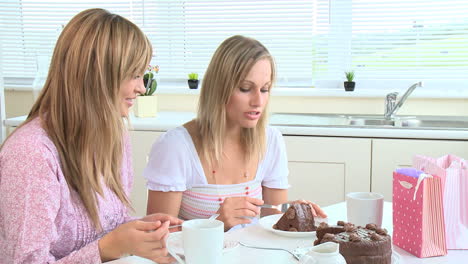 happy young women eating chocolate cake