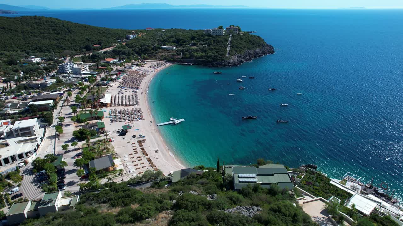 Quiet Ionian Beach in Albania with Turquoise Water, Bars and restaurants offer Tourists Relaxing