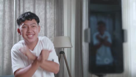 Asian Boy Dancing While Shooting Video Content For Social Networks With A Smartphone Camera