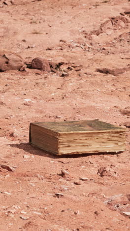 old book in red rock desert