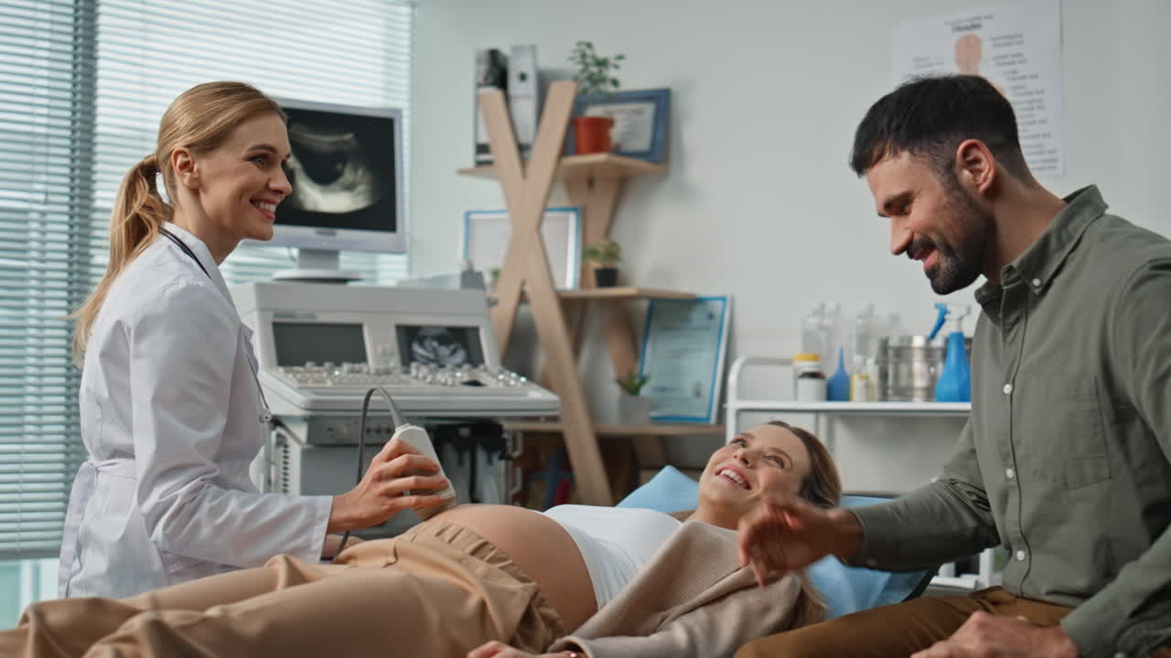 Expecting parents visiting ultrasound examination at clinic feeling excited