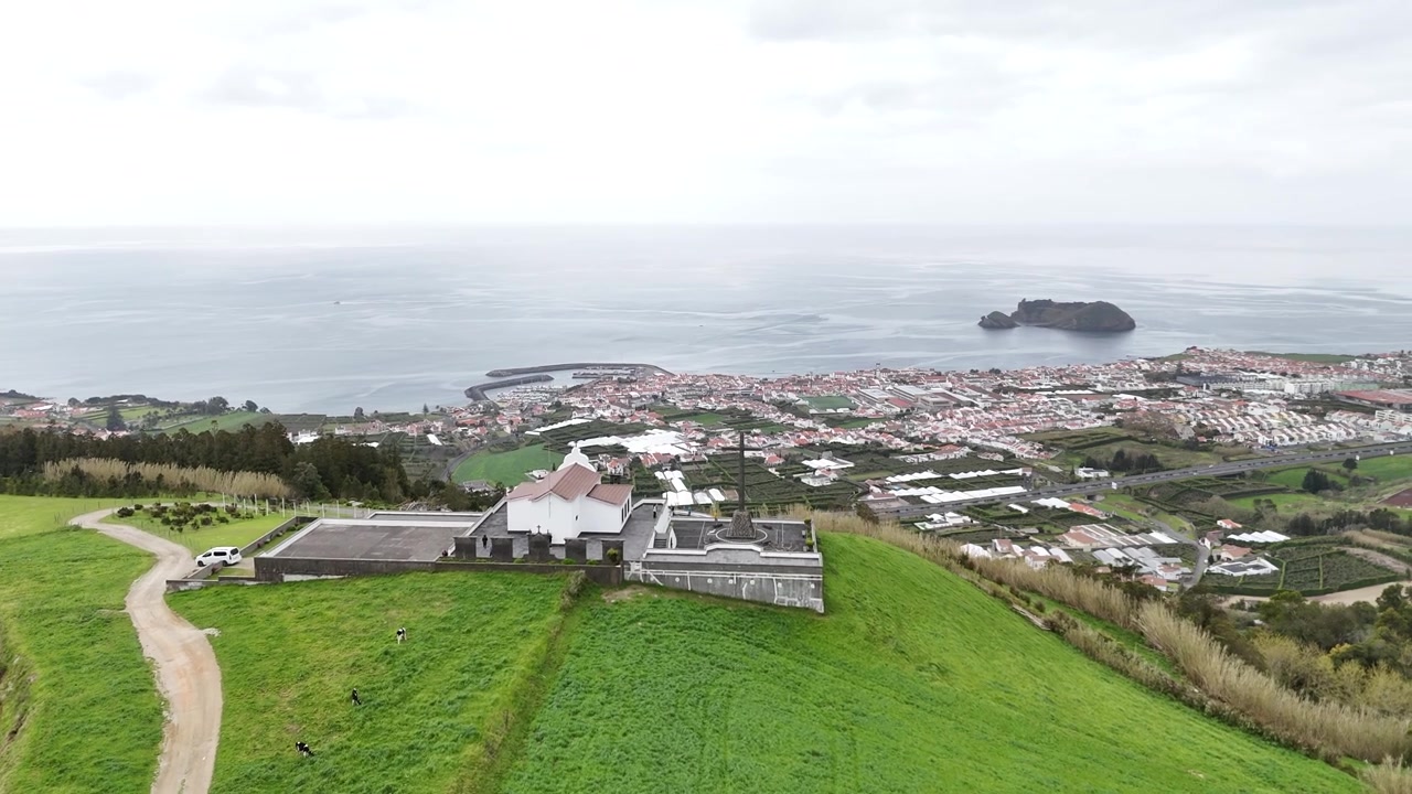 Vista aerea panoramica del santuario di Nossa Senhora da Paz che si affaccia sull'Oceano Atlantico e Vila Franca do Campo. Ripresa con drone dell'iconica chiesa in cima alla collina e dell'isolotto in lontananza.