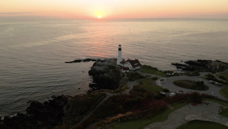 serene flyover drone shot of the portland headlight in portland, maine during sunrise