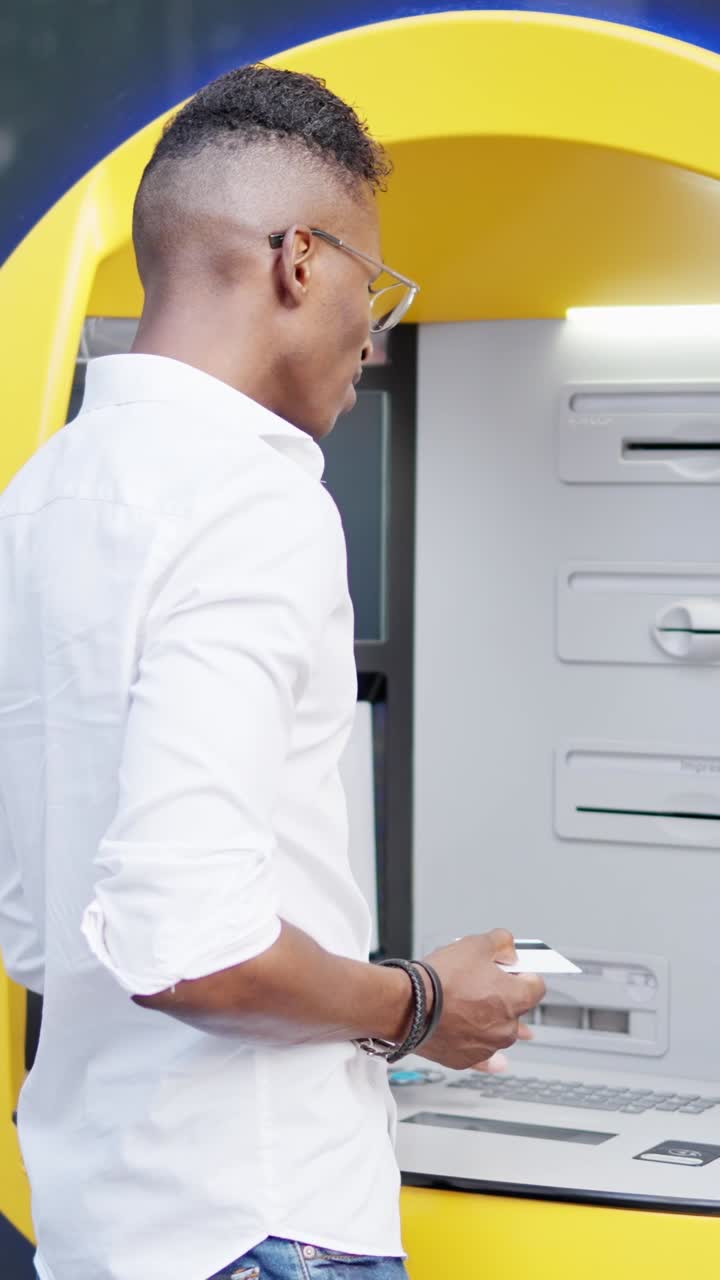 Man Interacting with an ATM for a Banking Transaction